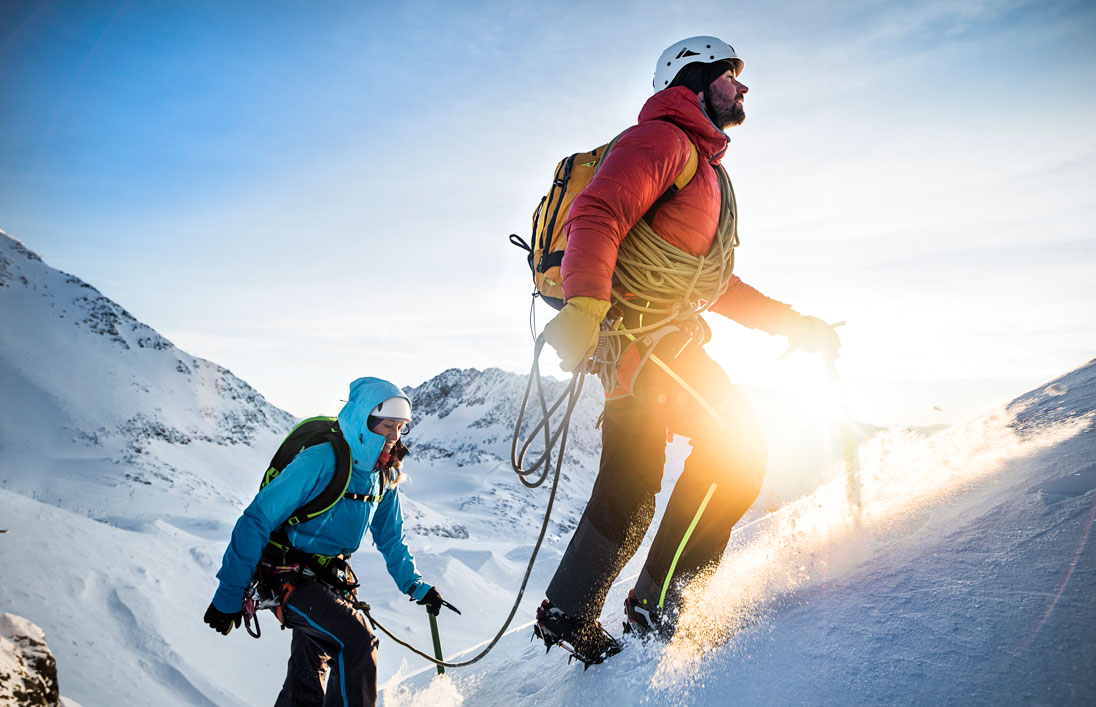 team of two climbers making heading up a snowy mountain