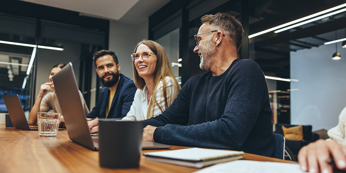 Colleagues chatting in a boardroom