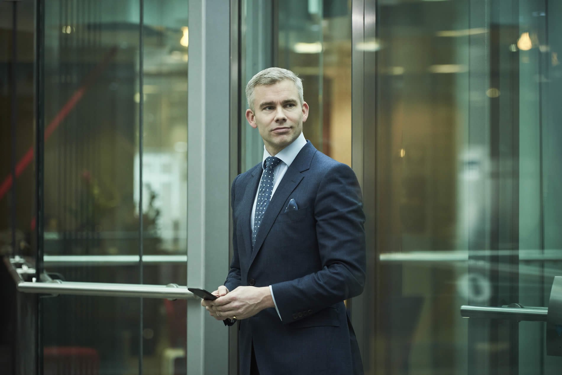 Tom Wilkinson (CEO), in lift.