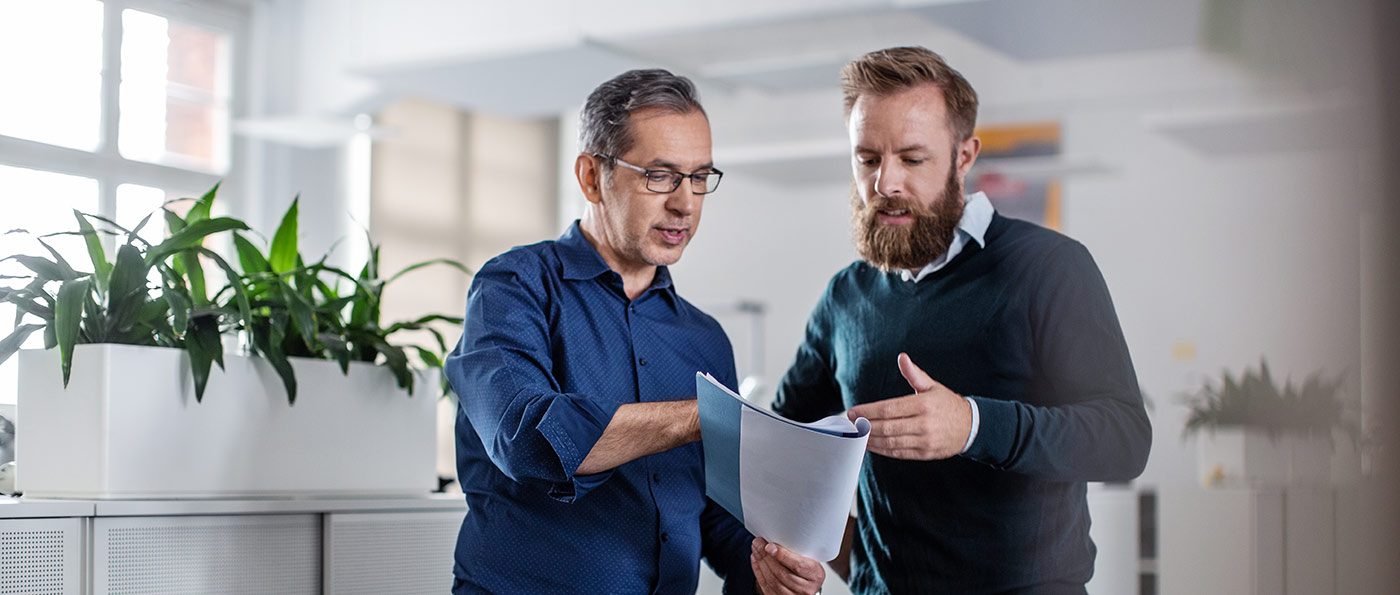 Two men chatting about a report