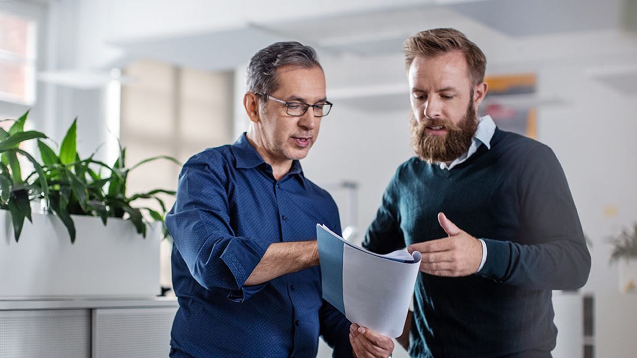 Two men chatting about a report