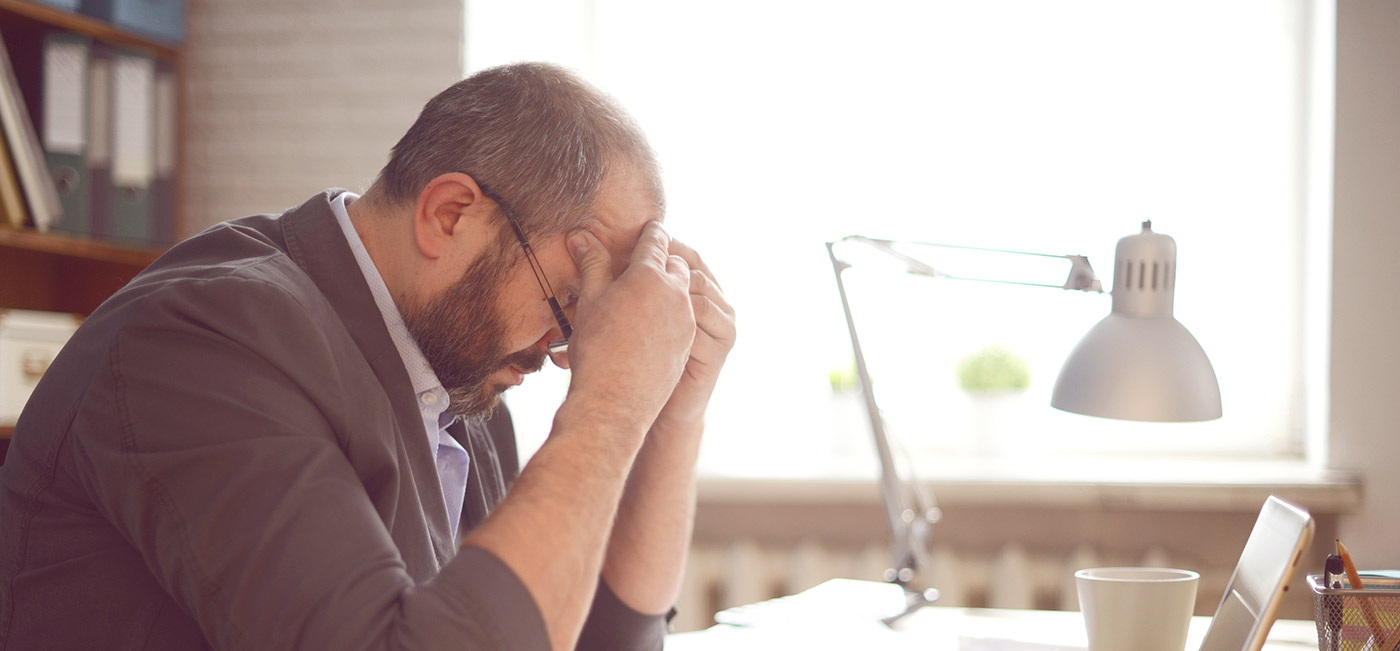 business man looking worried at desk
