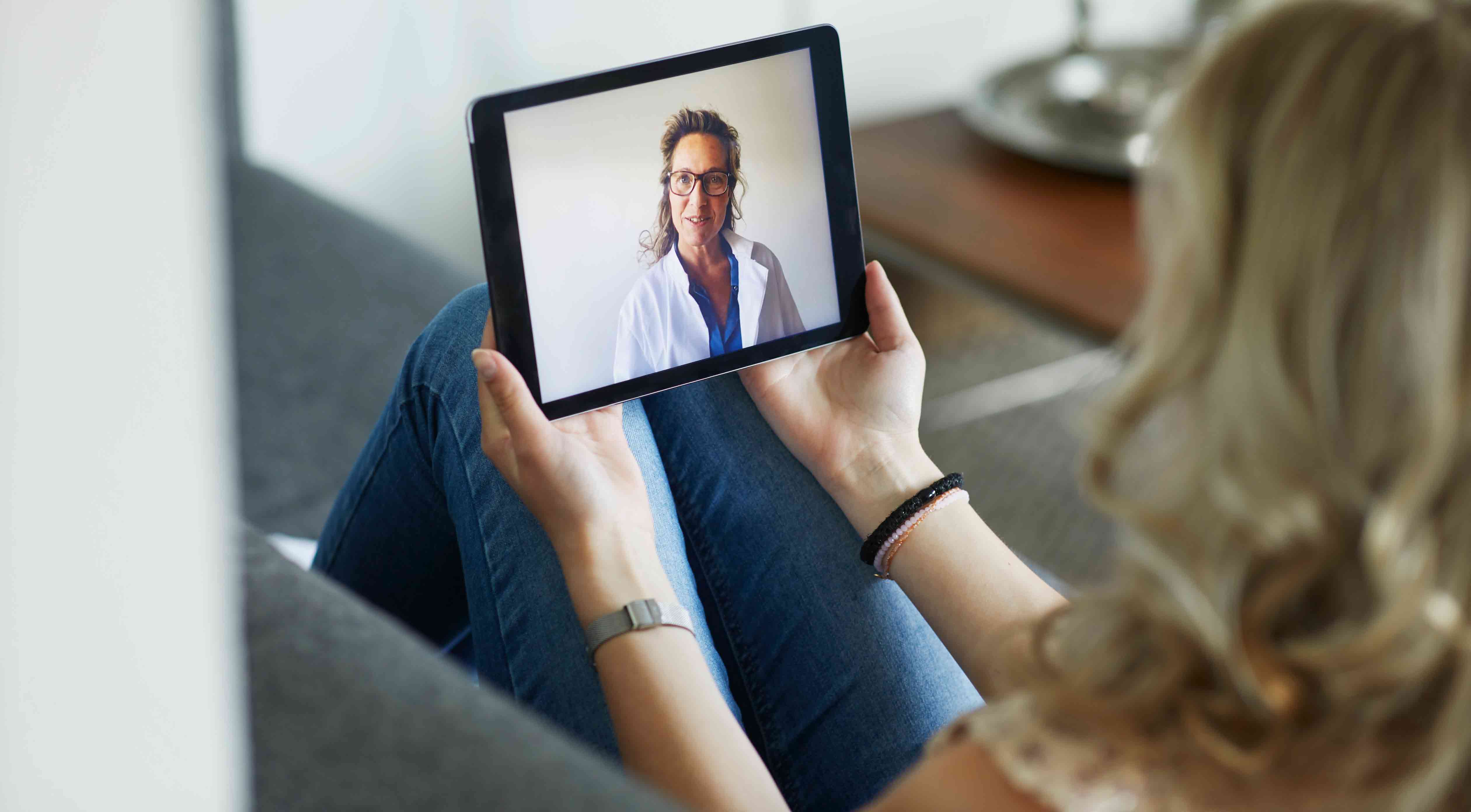 Woman-having-consultation-with-doctor-on-tablet