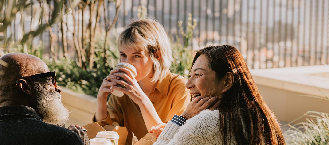 People chatting and drinking coffee outside