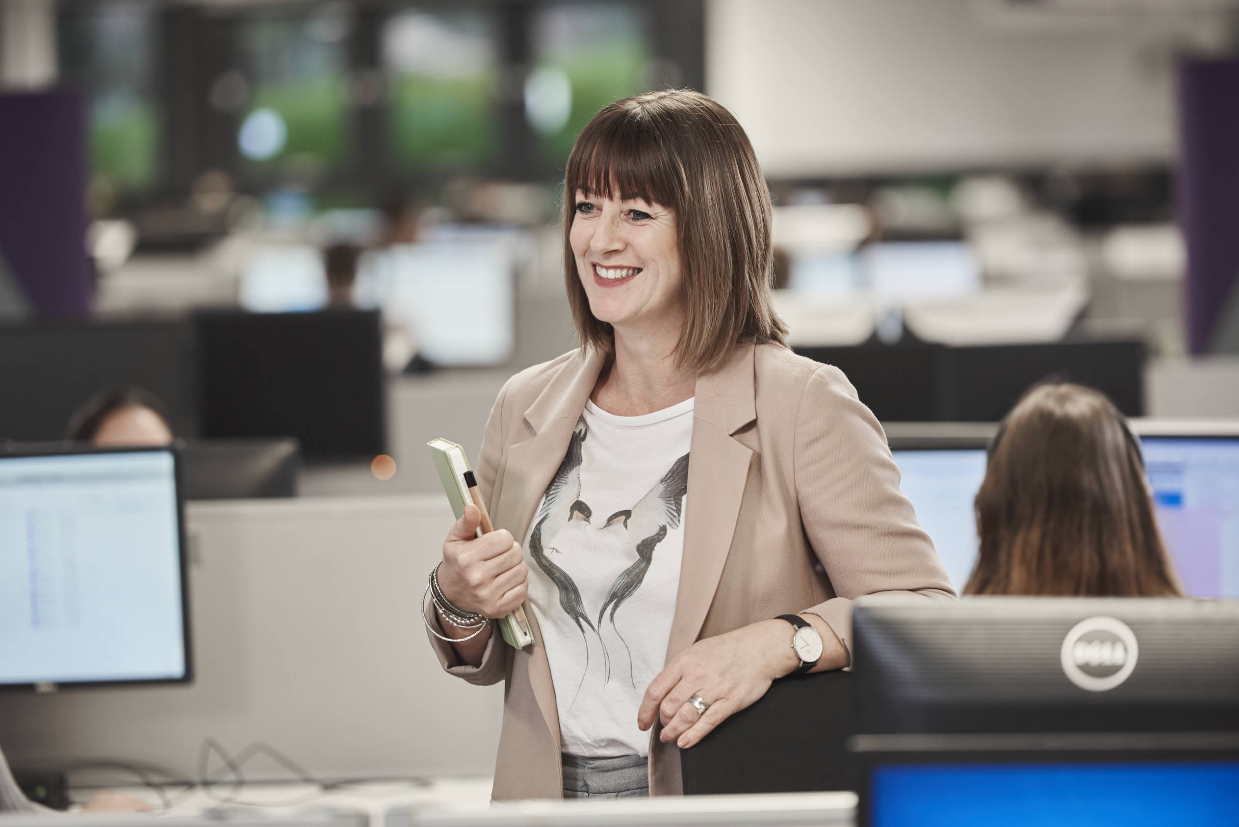 AXA employee in the office smiling.