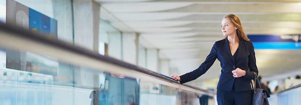 Woman in airport using travelator