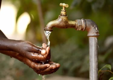 hands being washed under outside tap