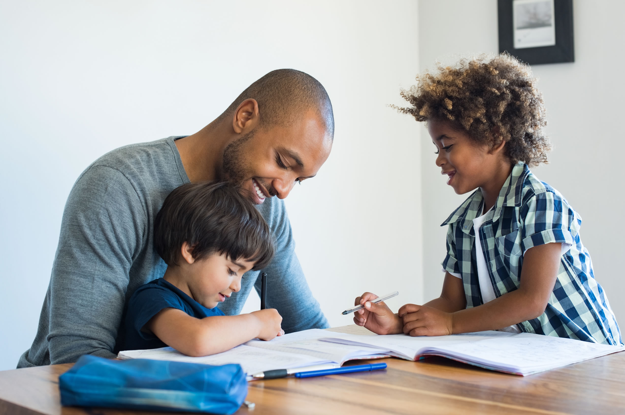 Father with sons doing homework