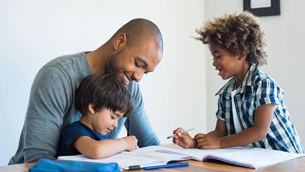 Father with sons doing homework