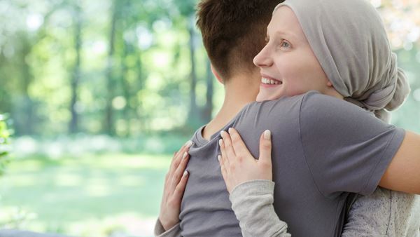 Cancer patient being hugged