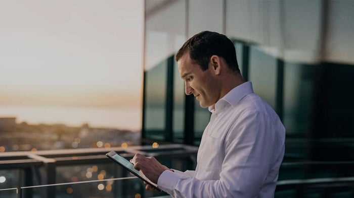 Business man looking at tablet device