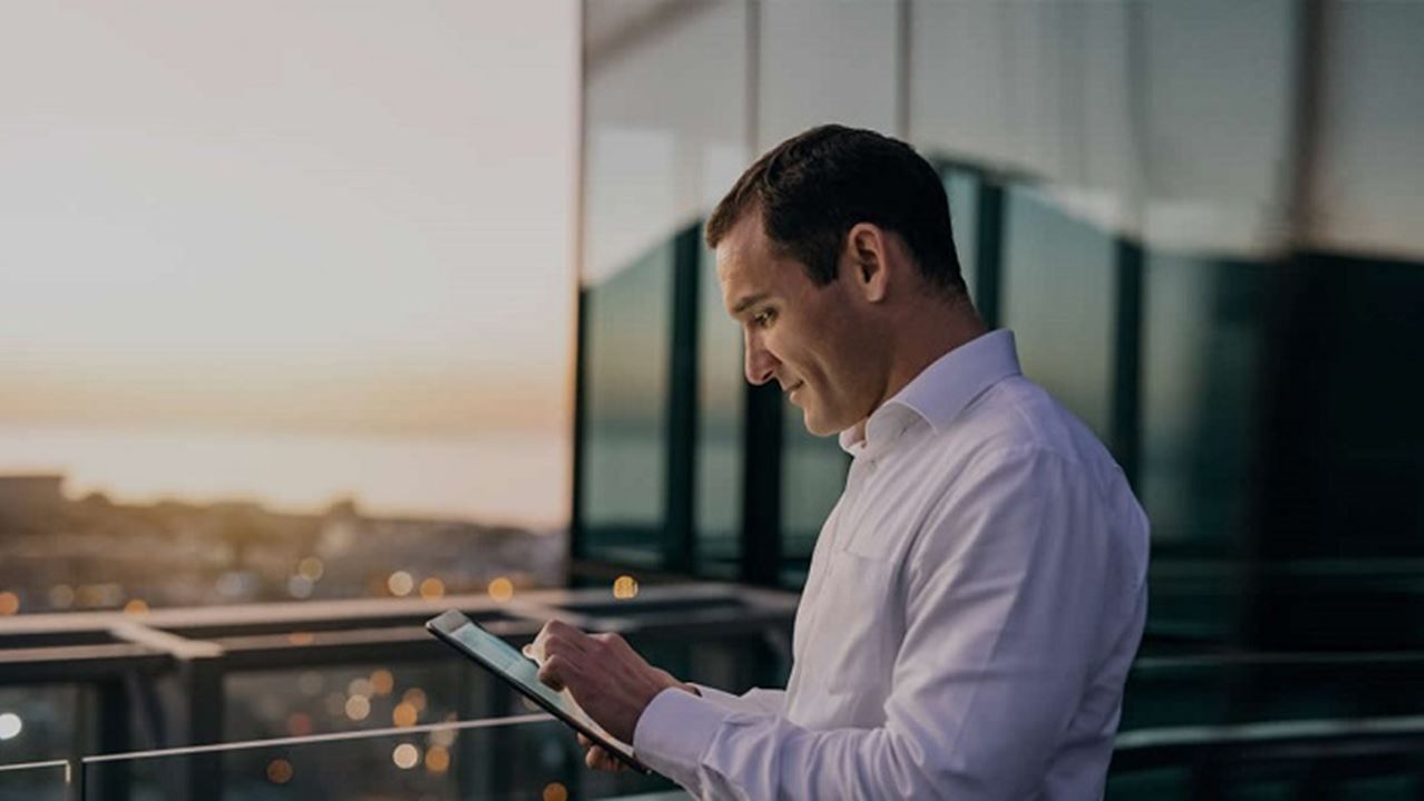 Business man looking at tablet device