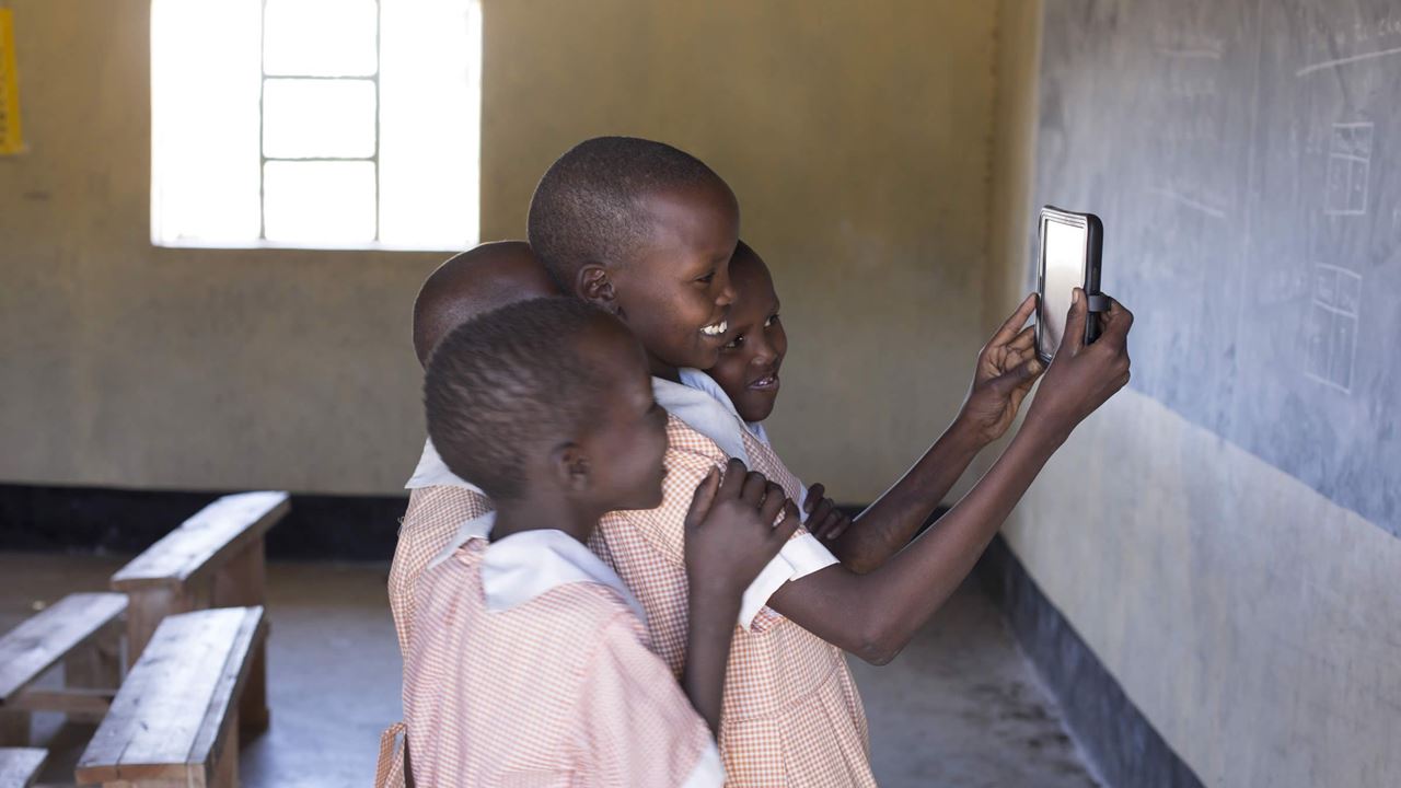 African children looking at tablet device