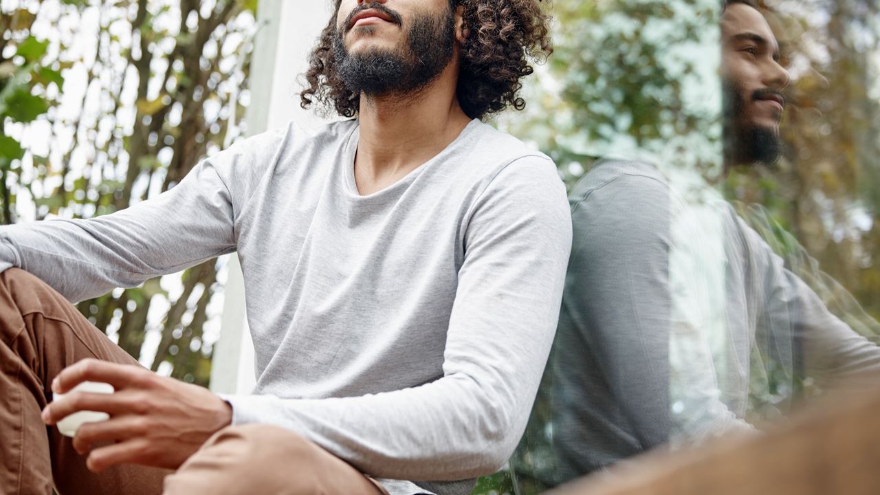 Man sitting outside with cup of coffee