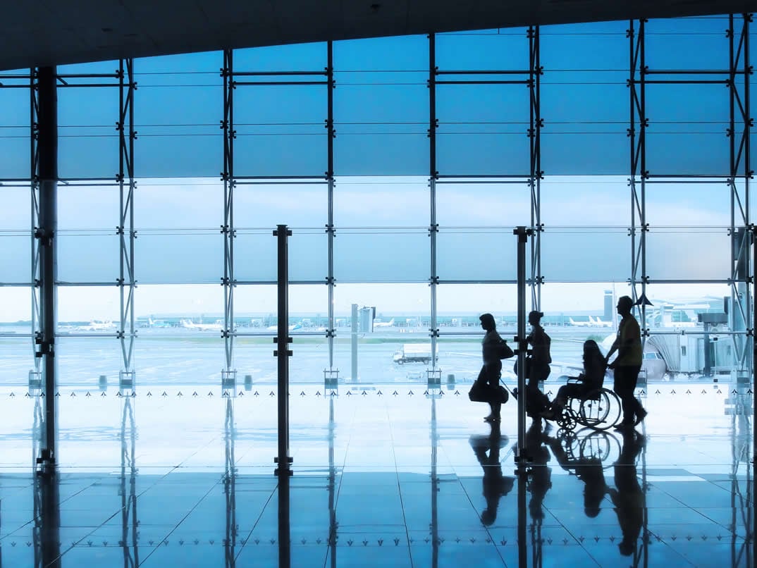 people moving through airport terminal