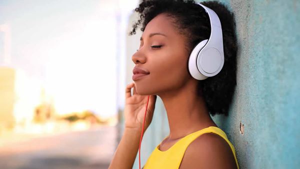woman listening to music using headphones