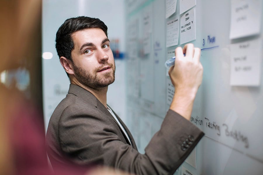 Man writing on noticeboard