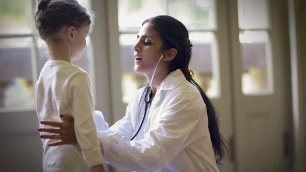 Female doctor with child patient