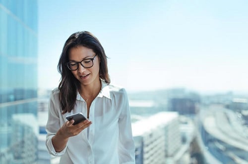 Lady in office looking at smart phone