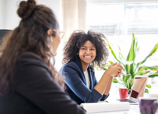 Two girls discussing on the work table