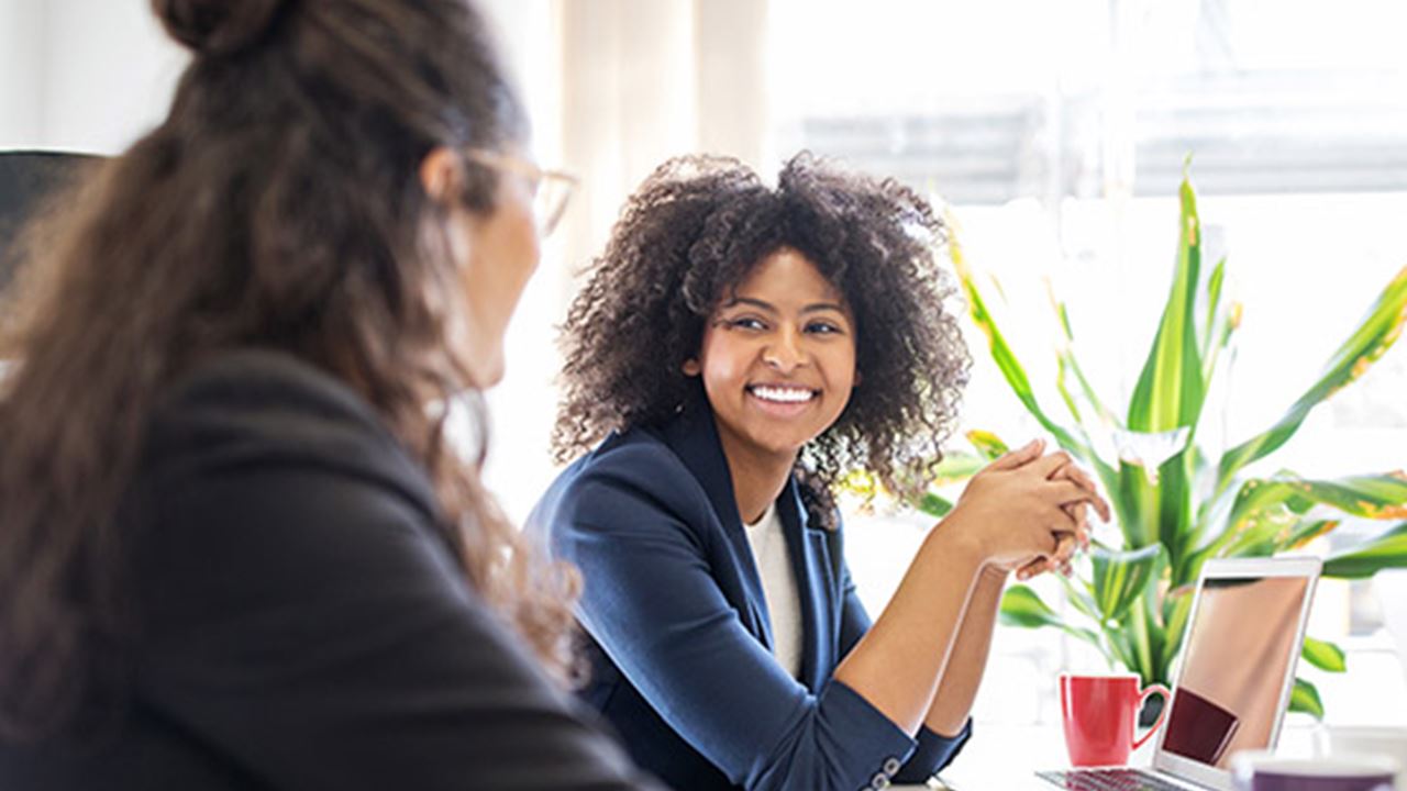 Two girls discussing on the work table