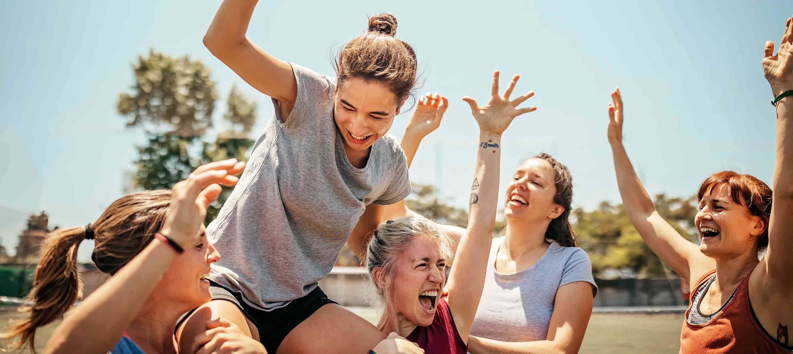 sportswomen celebrating a team member