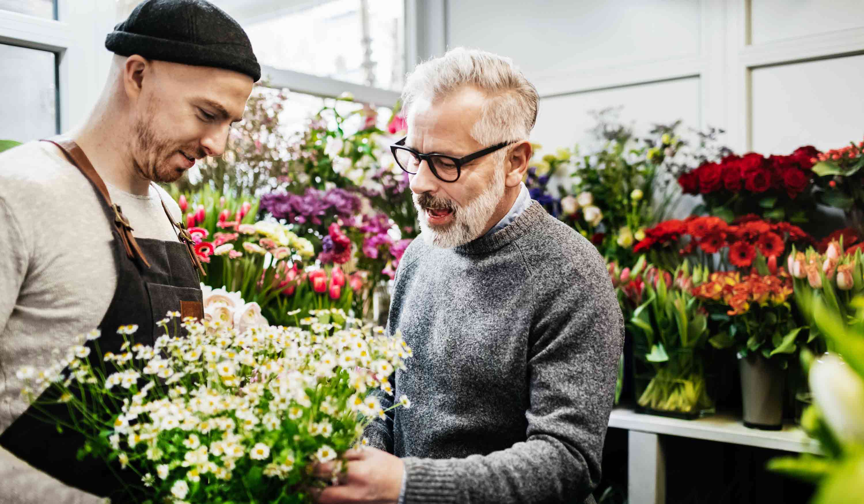 Men negotiating in flower shop