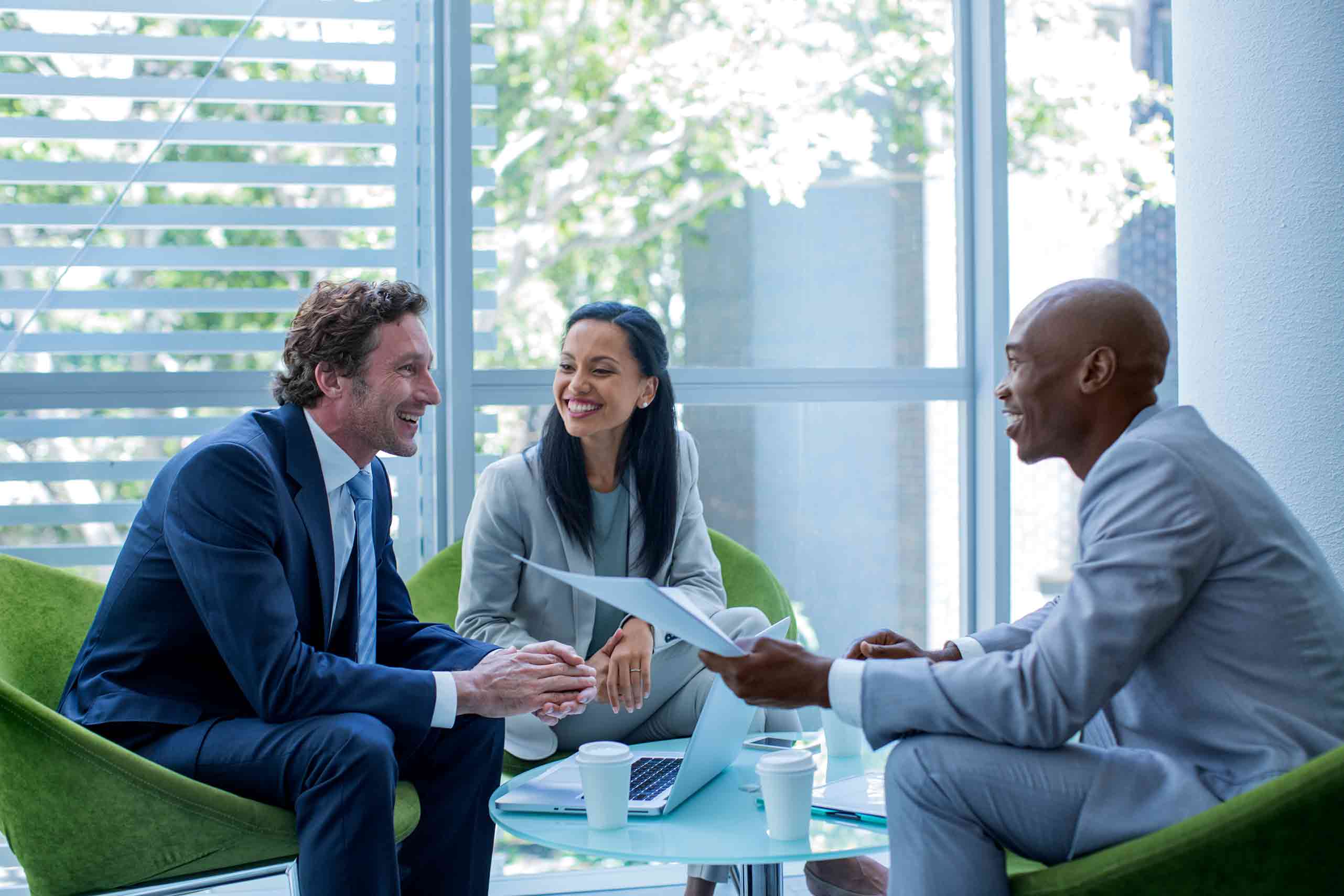 Diverse businesspeople sitting smiling