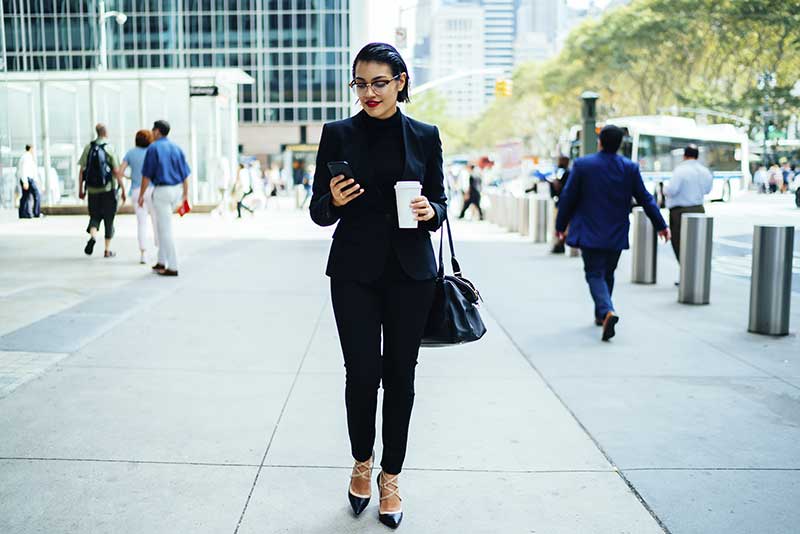 business woman walking down street