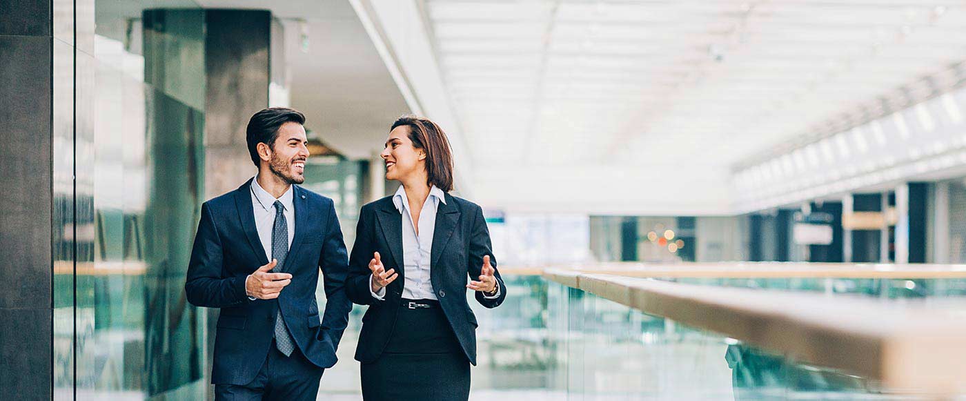Man and woman in business attire talking