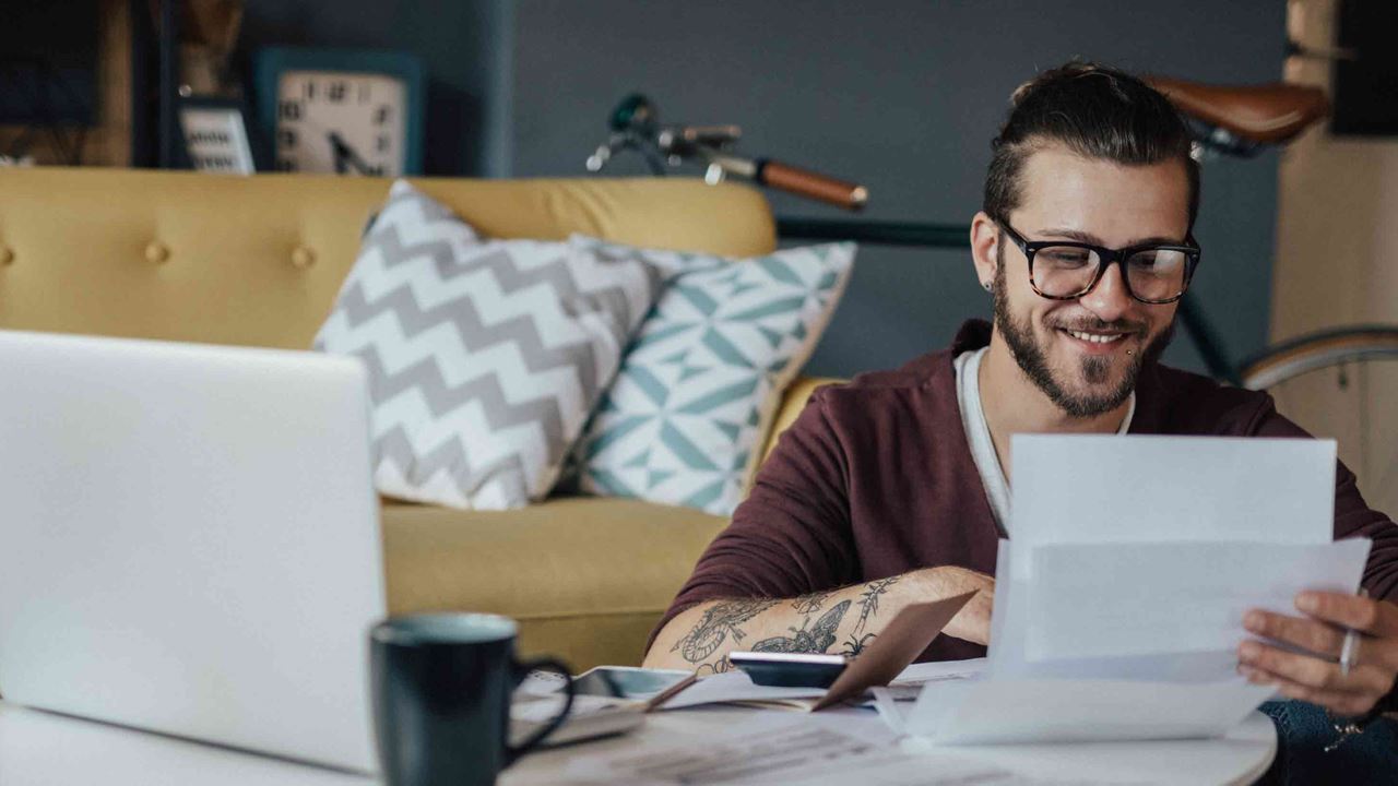 man-smiling-at-papers