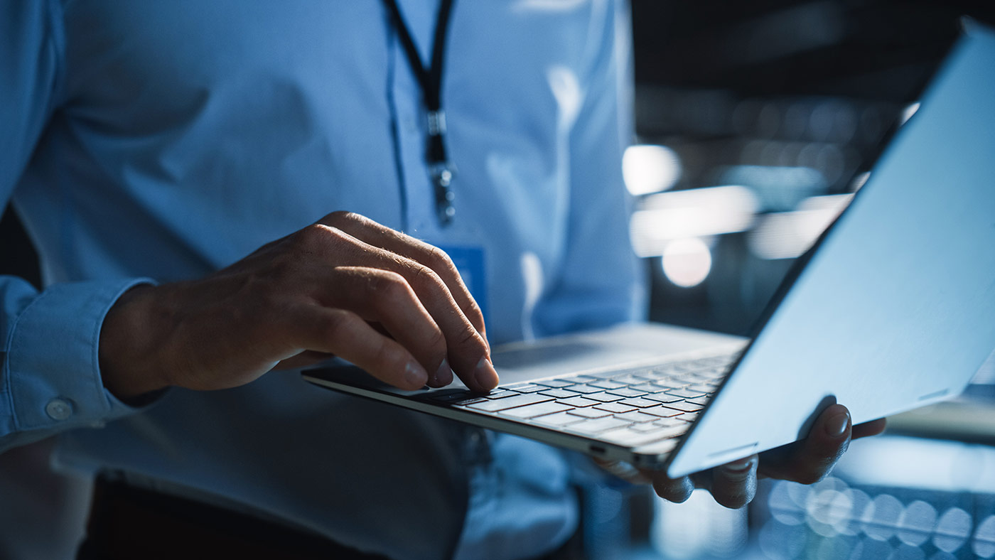 man working on laptop in a business setting