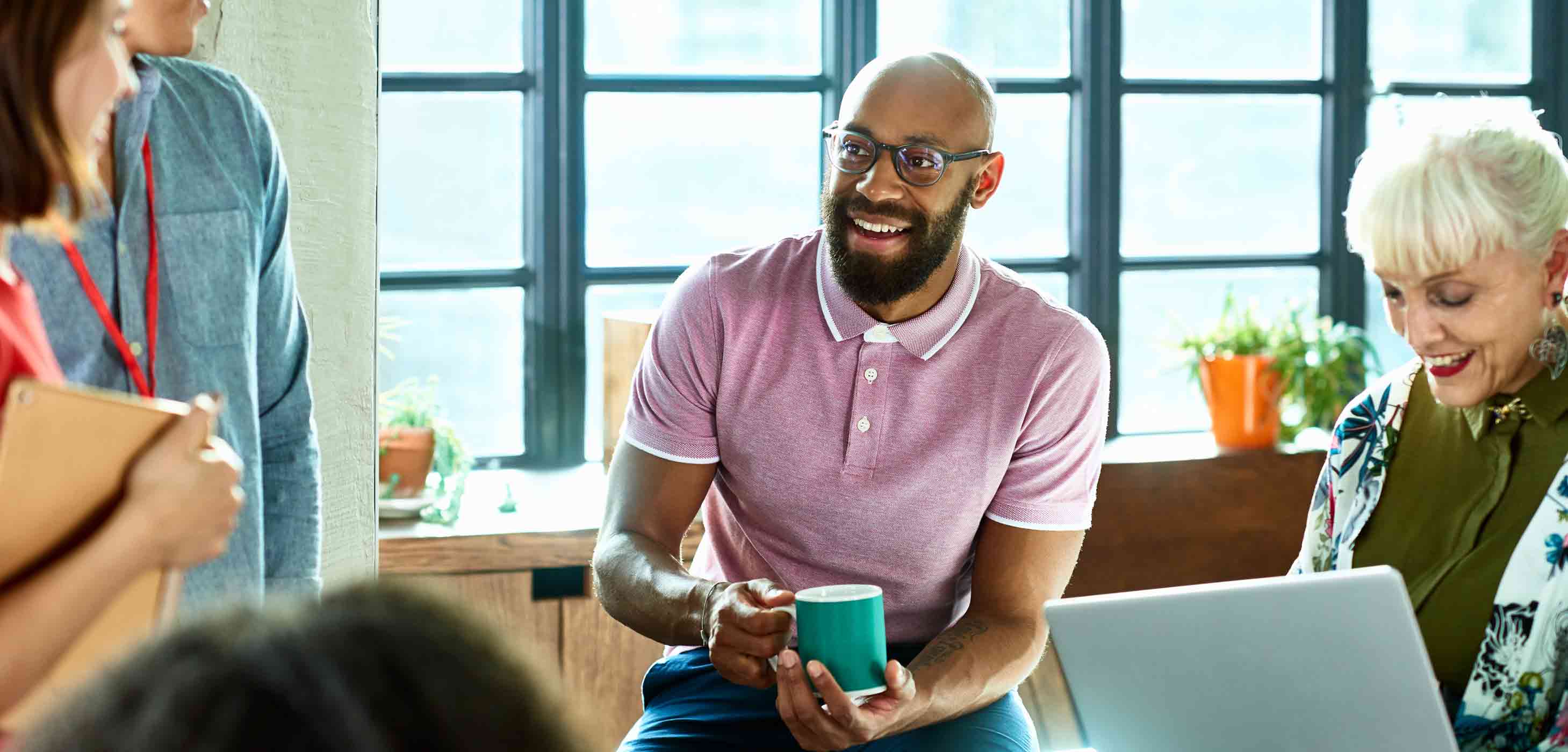Vibrant team chatting in bright office