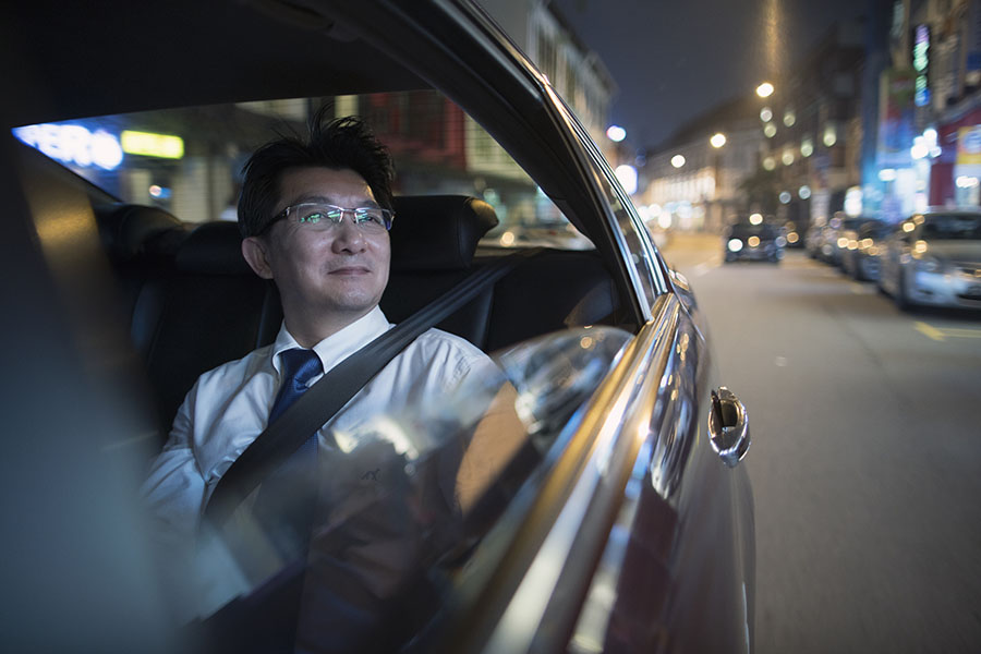 Man in the back of car looking at sights