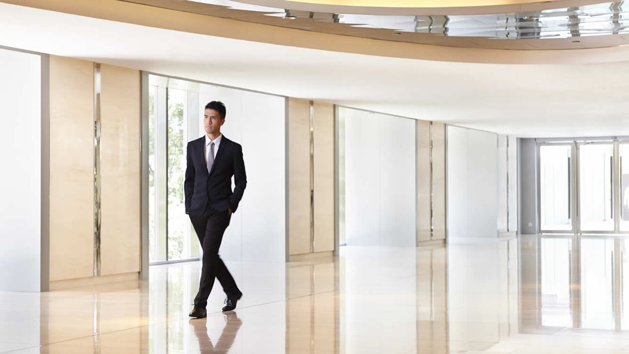 man walking through building lobby
