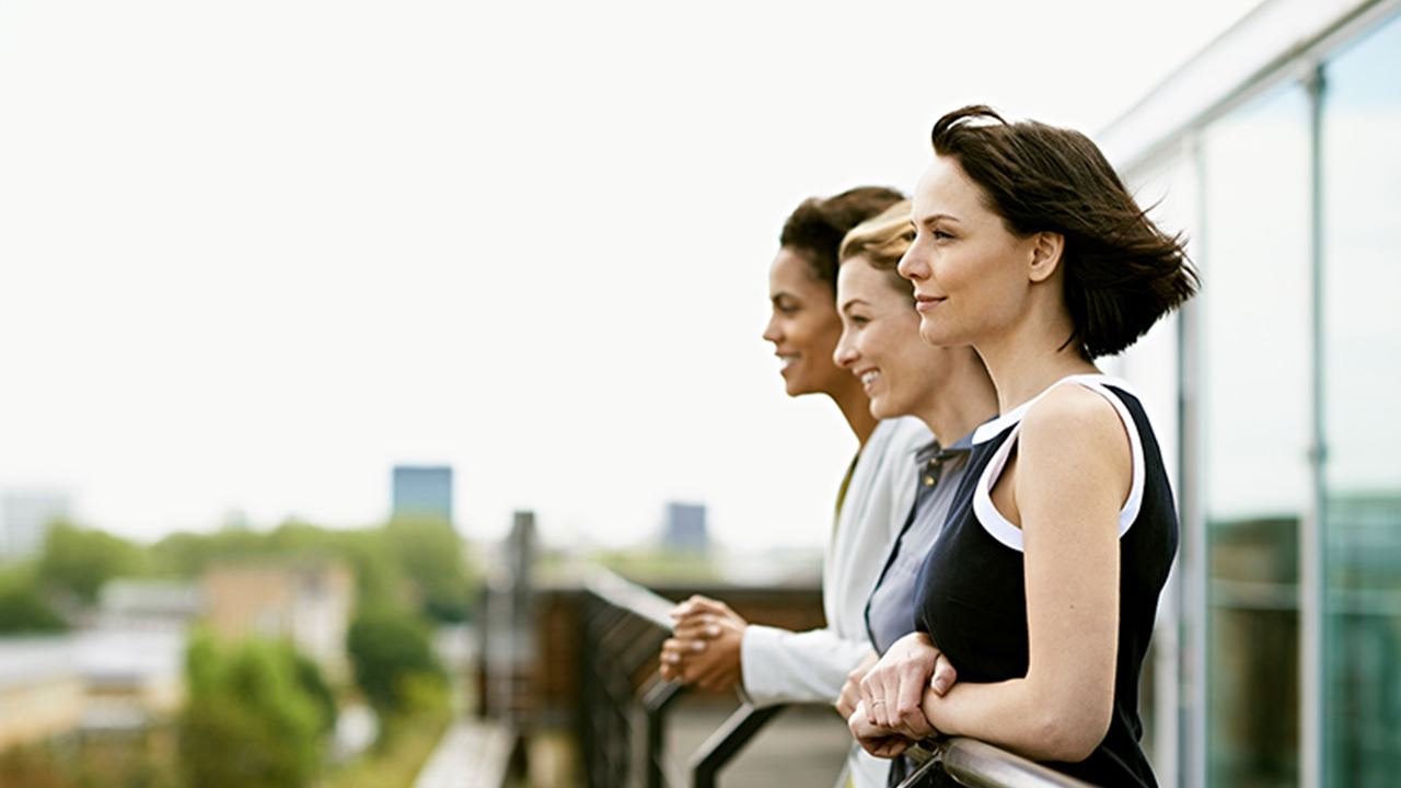 Three women looking outside the balcony
