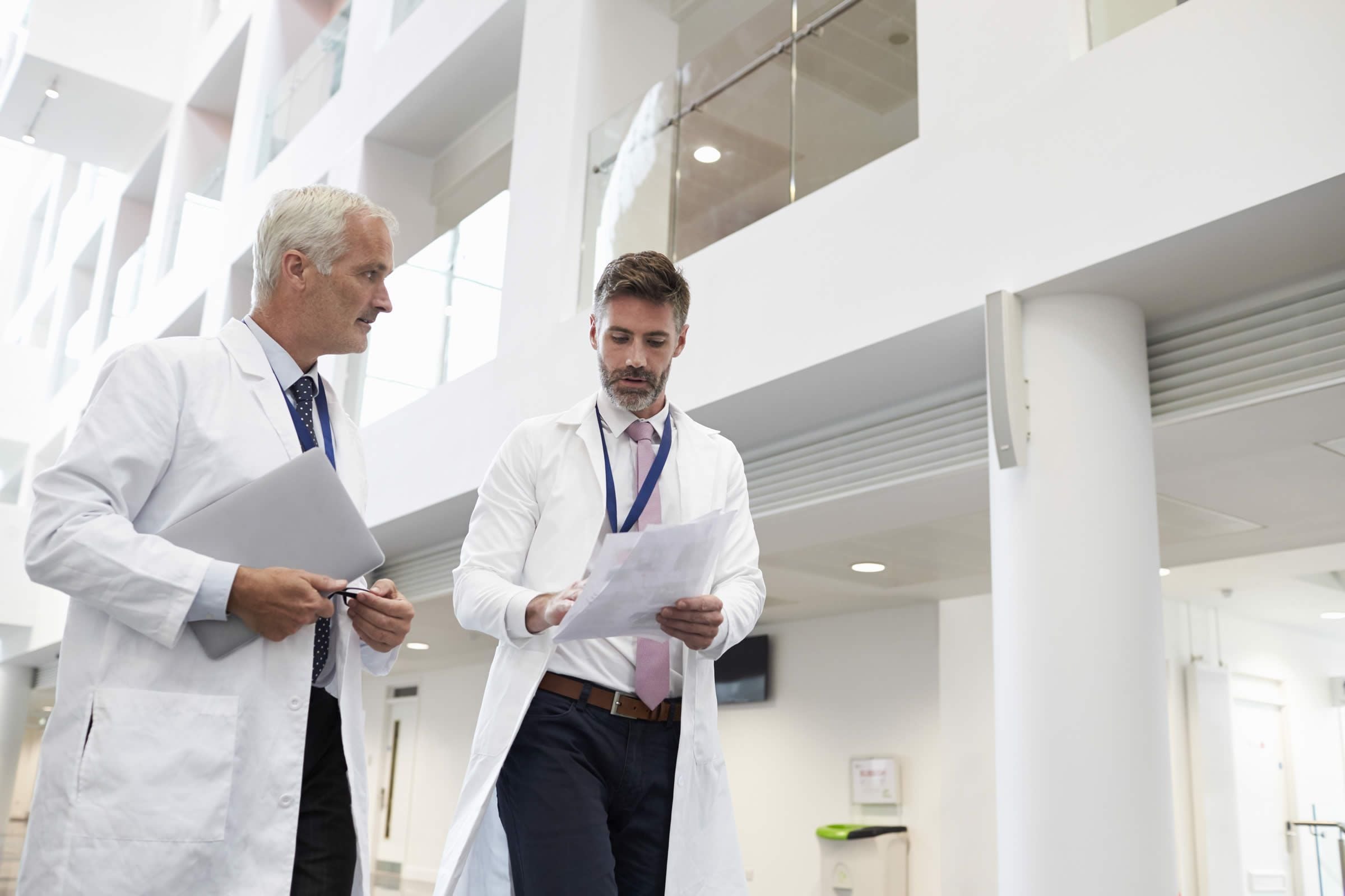Male doctors walking down corridor