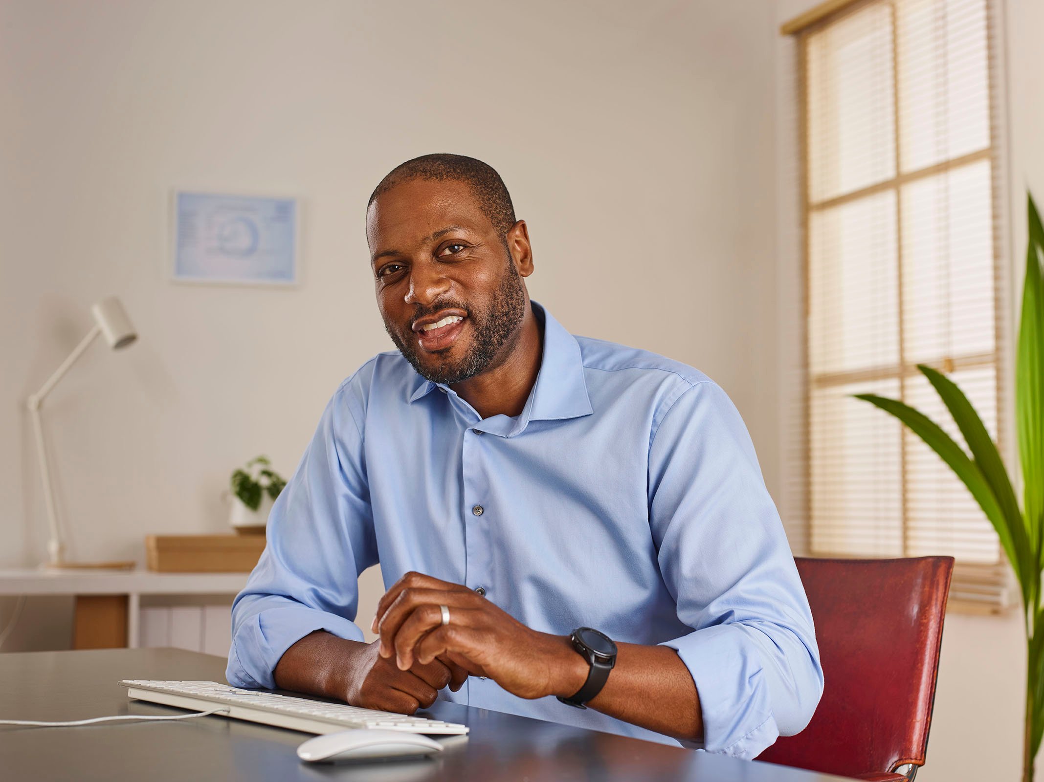 man smiling by desk