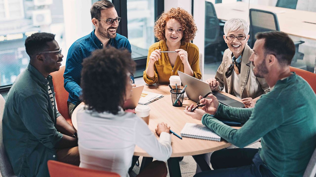 Smiling diverse team chatting around a table