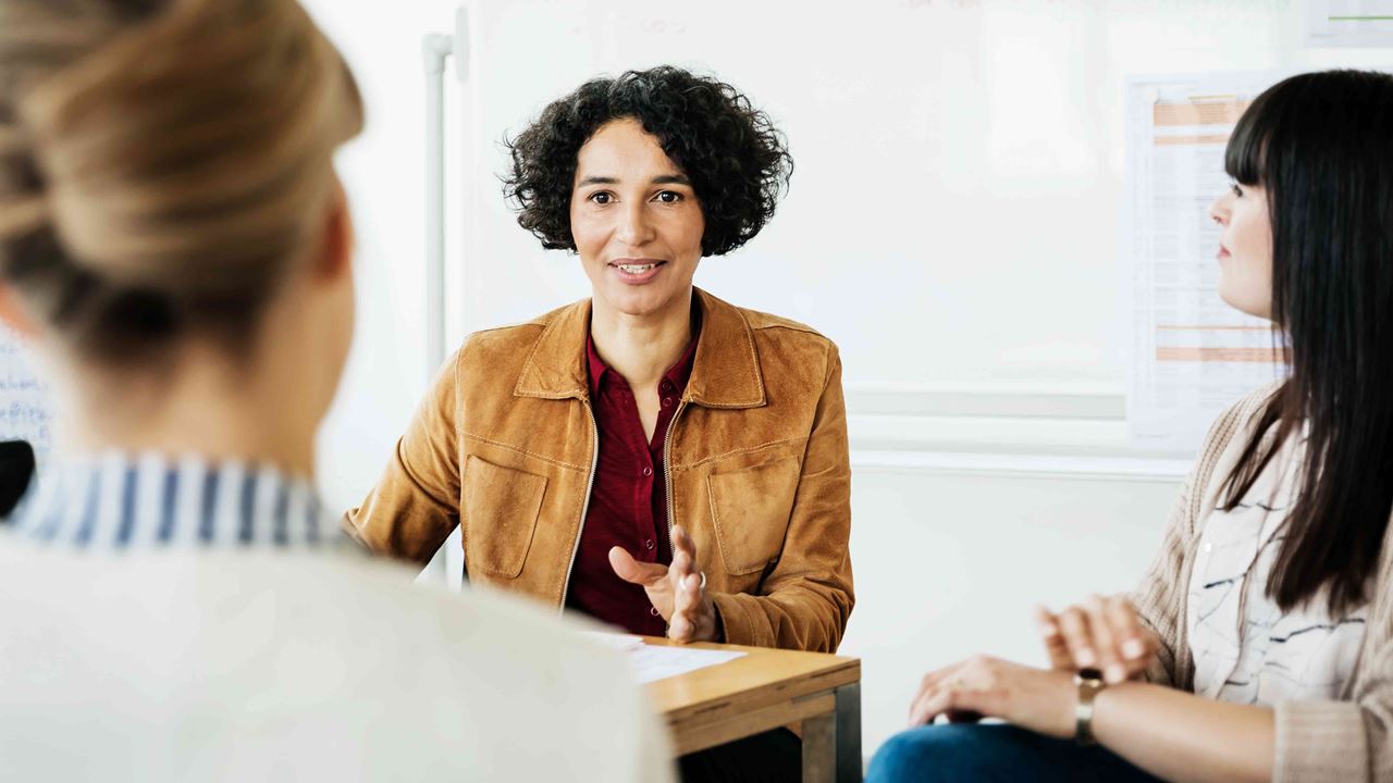 Women having a discussion in their office.