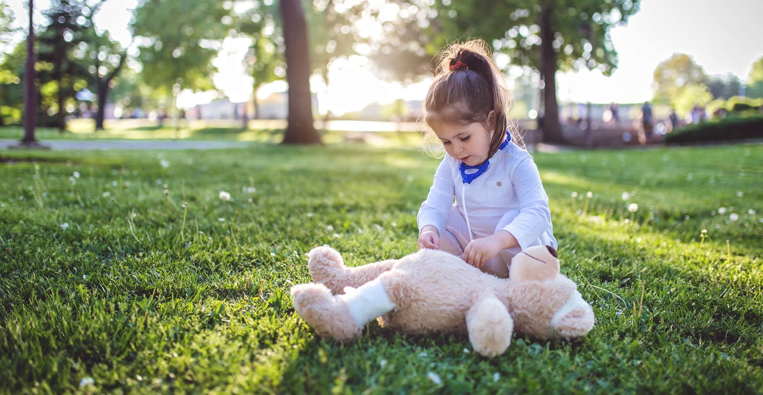 girl playing doctor with teddy