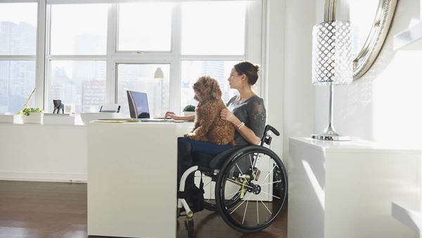woman sat at desk with dog