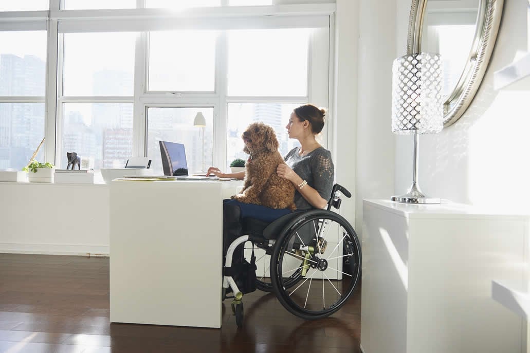 woman sat at desk with dog