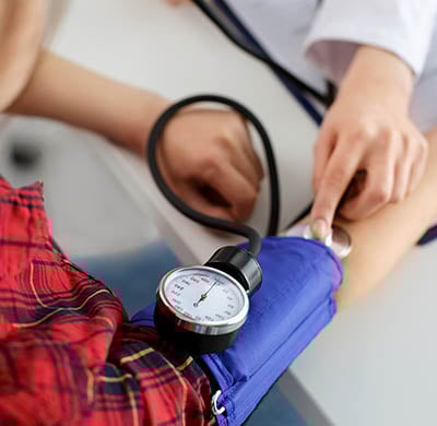 Doctor taking patients blood pressure