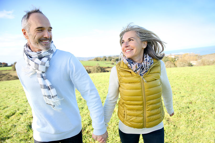 Couple walking in field