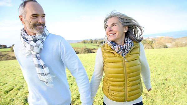 Couple walking in field