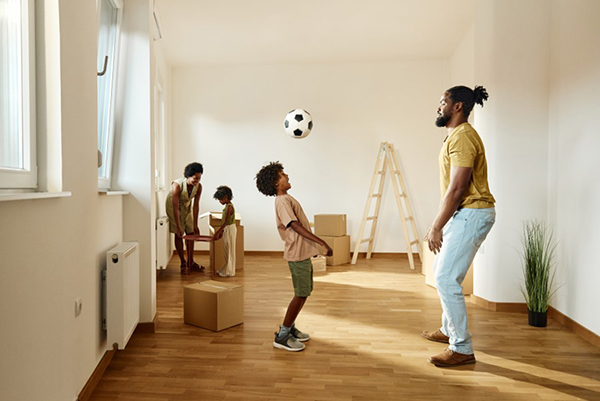 father and son playing football