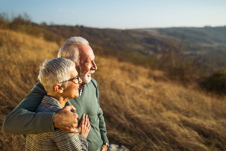 elderly couple looking at a field