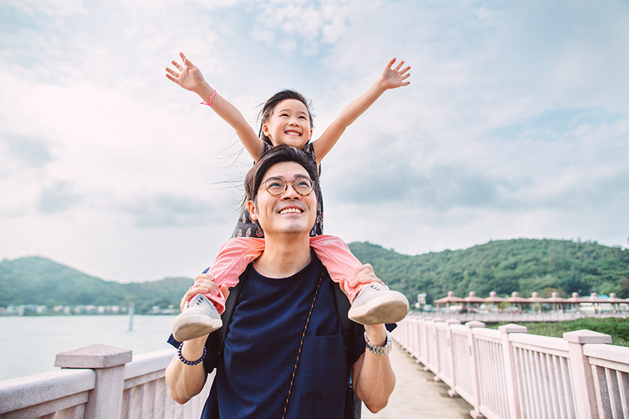 Father with young daughter on his back