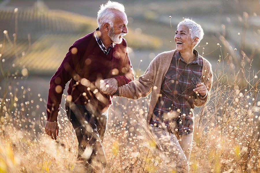 Smiling man and woman in a field 